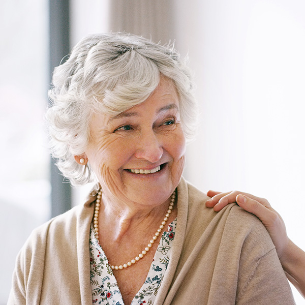 Happy elderly woman smiling showing her teeth