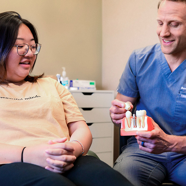 Dentist from Minnesota Dental Surgery and Implant Center explaining dental implants to patient