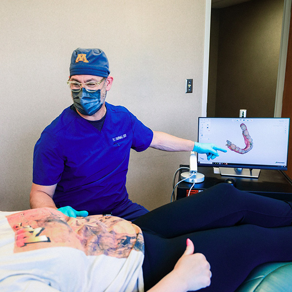 Dentist from Minnesota Dental Surgery and Implant Center explaining dental implants to patient