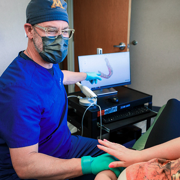 Dentist from Minnesota Dental Surgery and Implant Center explaining dental implants to patient