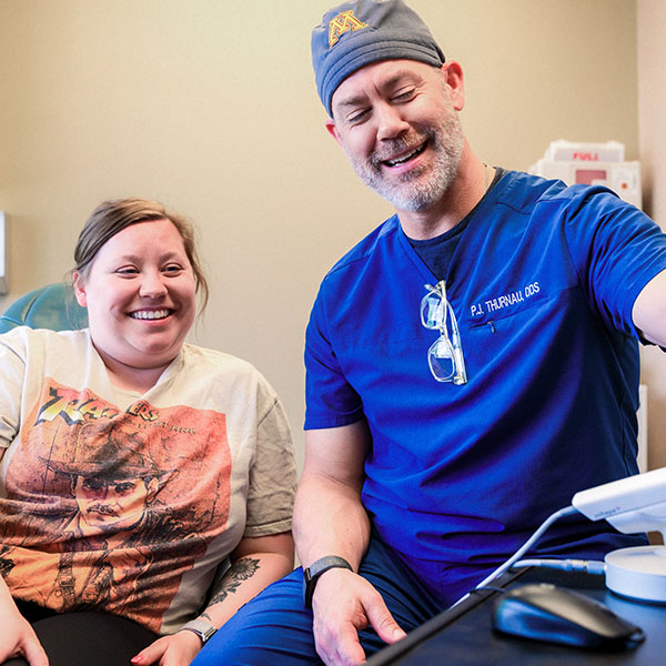 Dentist from Minnesota Dental Surgery and Implant Center explaining dental implants to patient