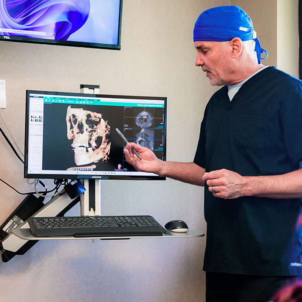 Dentist from Minnesota Dental Surgery and Implant Center explaining x-rays to patient