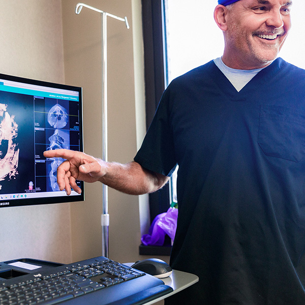 Dentist from Minnesota Dental Surgery and Implant Center showing x-ray to patient