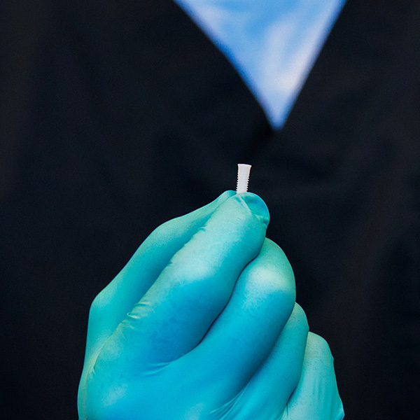 Dentist from Minnesota Dental Surgery and Implant Center showing dental implant to patient