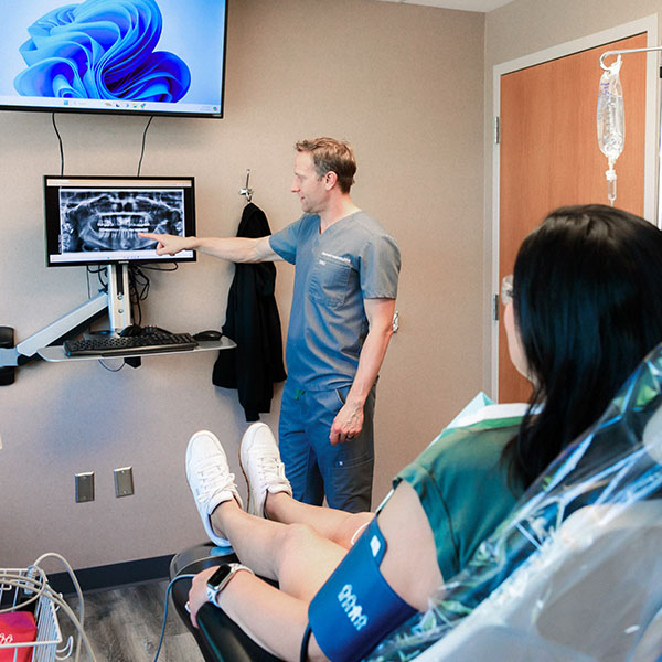 Dentist from Minnesota Dental Surgery and Implant Center showing patient her results from the x-rays