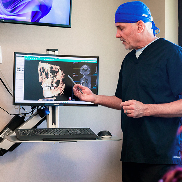 Dentist from Minnesota Dental Surgery and Implant Center explaining x-ray to patient