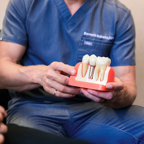 Dentist from Minnesota Dental Surgery and Implant Center explaining dental implants to patient