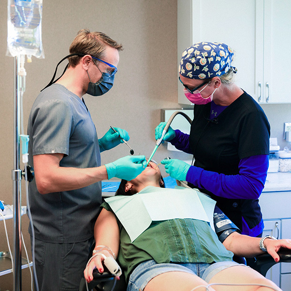 Dentist from Minnesota Dental Surgery and Implant Center performing surgery on a patient